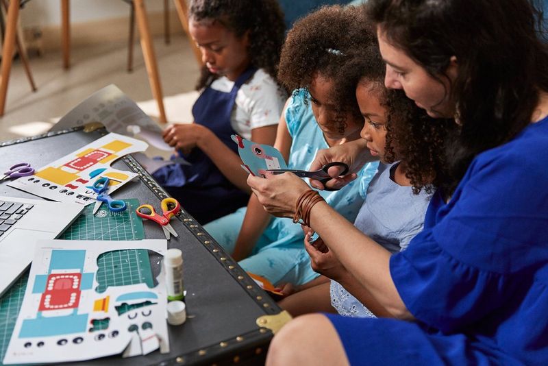 A family cutting out papercraft animal shapes.