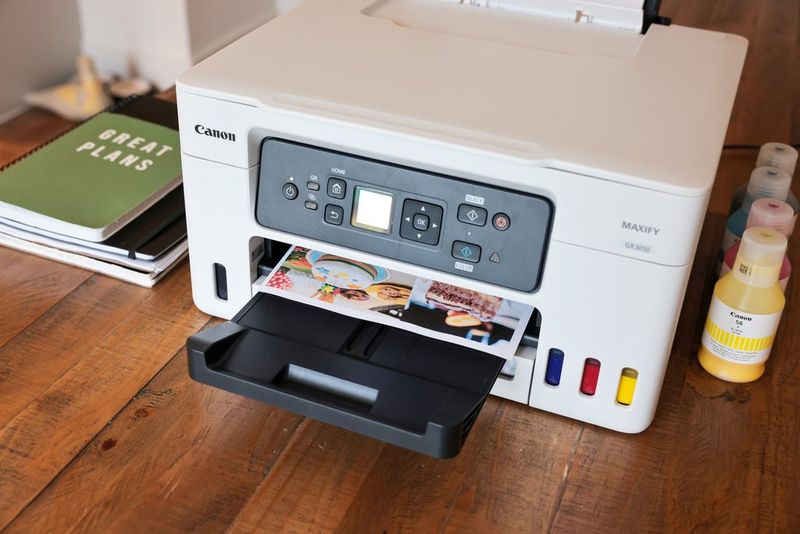 A bespoke poster created with Canon PosterArtist emerging from a Canon MAXIFY printer.