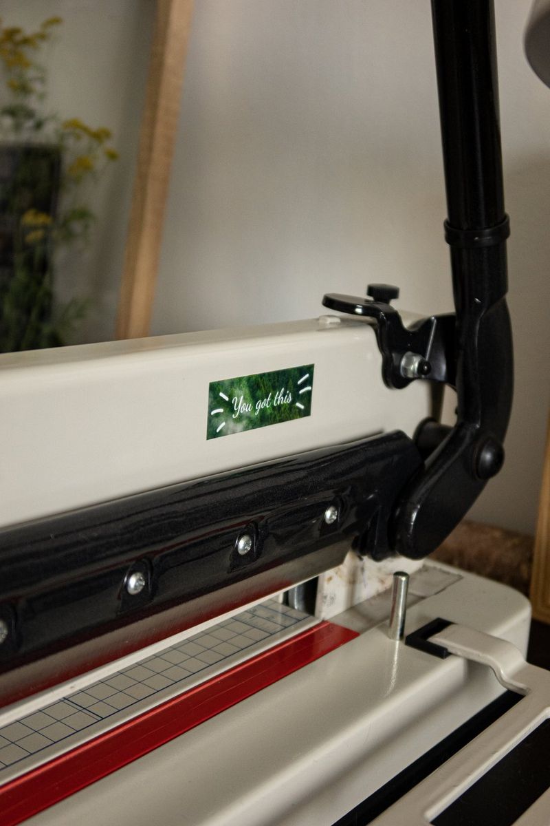 A printed homemade label, with the phrase "You got this", stuck onto an office machine.