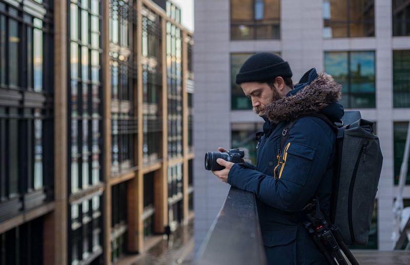 Filmmaker Matthew Vandeputte uses his camera from an elevated position among city buildings. © Pete Jobson