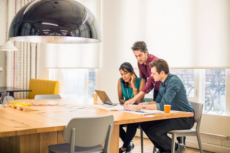 a group of professionals working together around a table