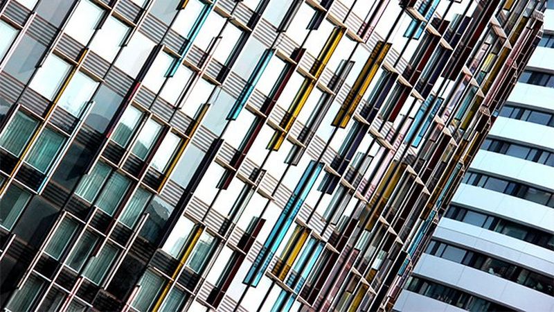 Two high-rise buildings overlapping each other on a slant.