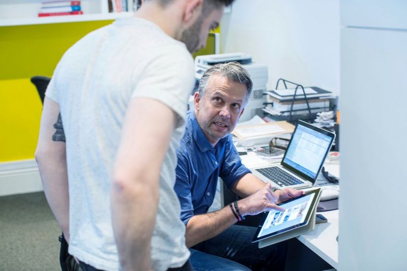 Two work professionals working in the office together