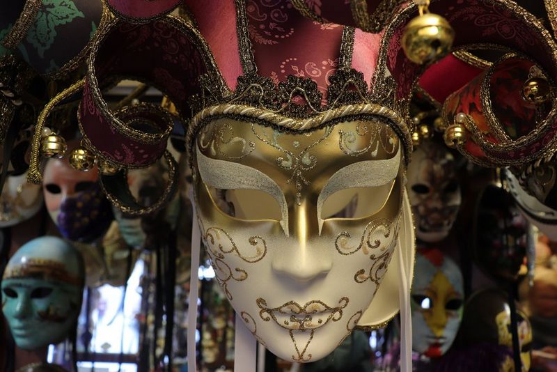 In a colour-corrected version of the same shot, the carnival mask appears white but other colours are dulled.