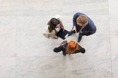 Bird's eye view camera shot of three adults talking