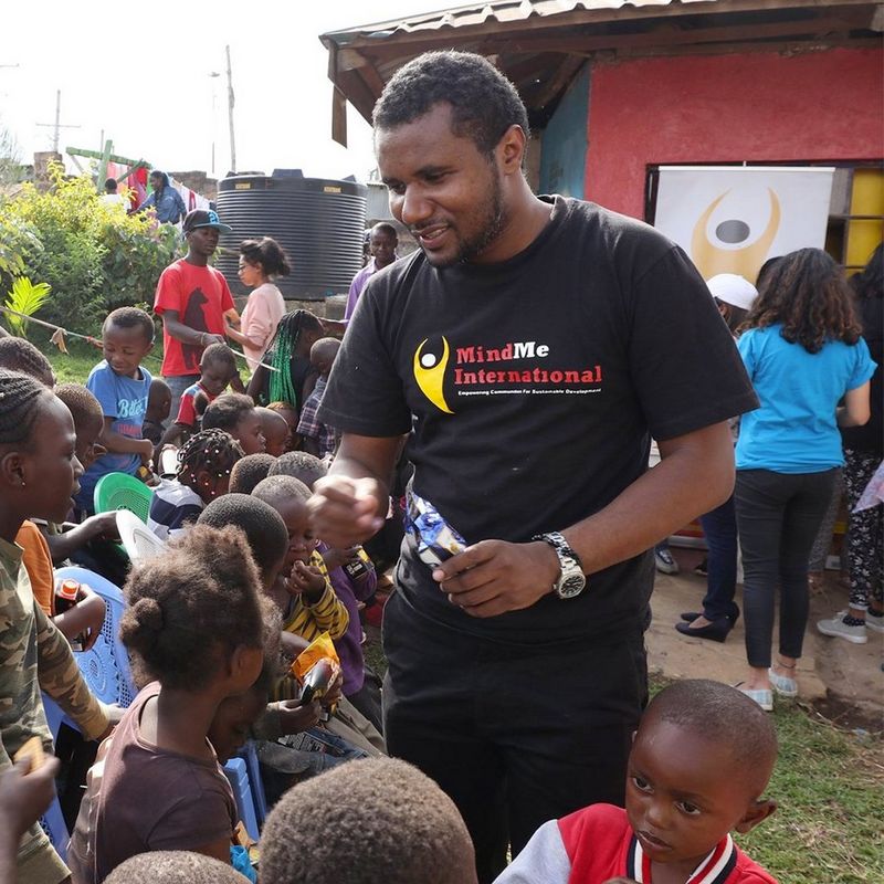 On the right, John Wambugu of MindMe International is surrounded by the children who use the Laibu Mtaani.