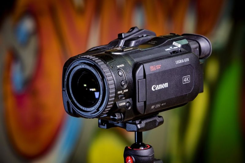 A Canon LEGRIA GX10 camcorder fixed to a tripod.