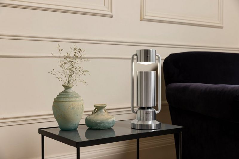 A Canon Light & Speaker ML-A sits on a side table next to an armchair.