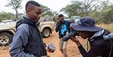 Neville Ngomane hold a piece of rhino horn after watching a dehorning