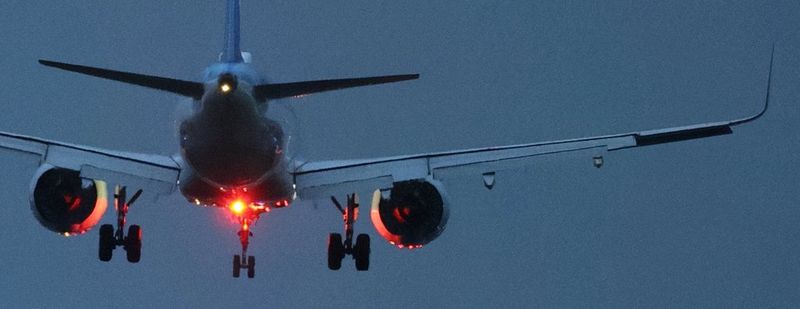 Detail of an image shot at high ISO of an aircraft flying against a dark blue sky, processed by image.canon's Cloud RAW image processing, so it appears sharper and less noisy. 