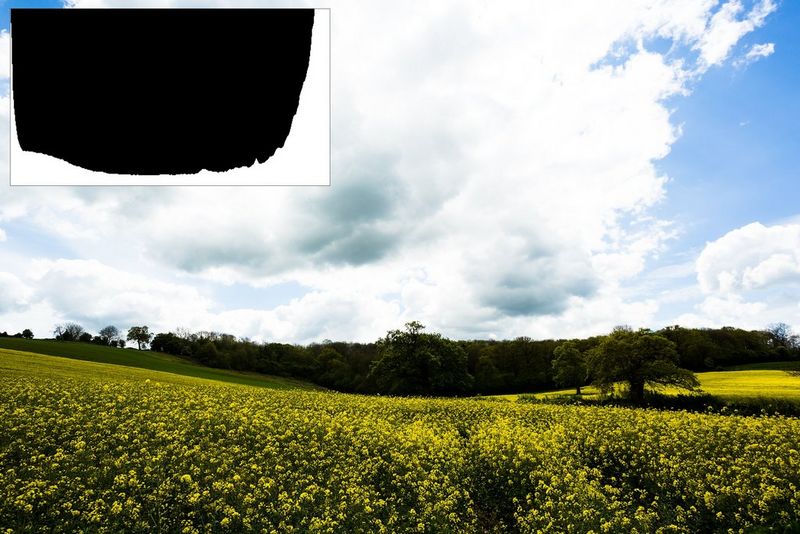 A high-contrast landscape image, with the histogram rising to a cut-off peak at both ends, highlights (right) and shadows (left).