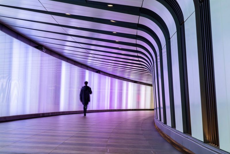 pedestrian walking through tunnel