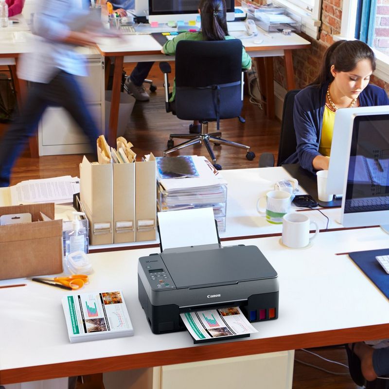 PIXMA G3560 with photo prints in an office desk