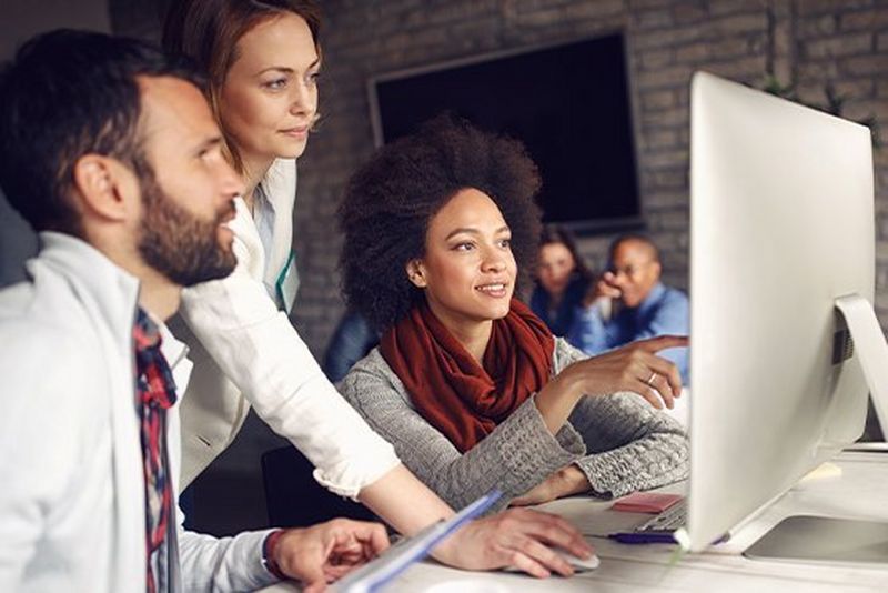 work professionals looking at a computer screen