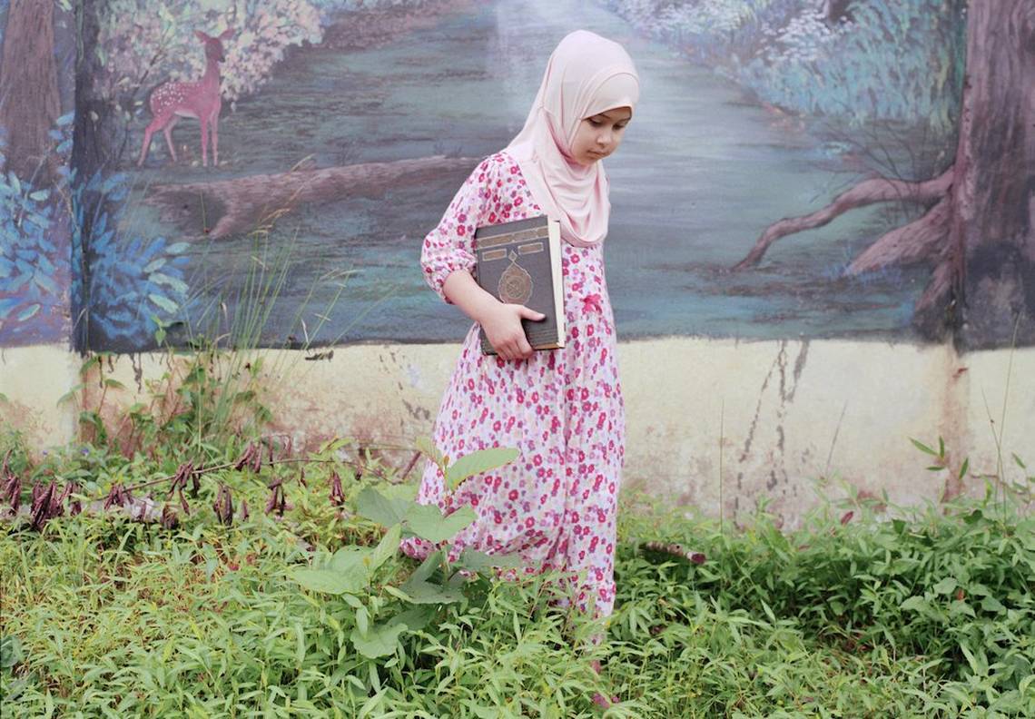 A young female student wearing a hijab walks through the grounds of the Qur'an school in Rize, Turkey.