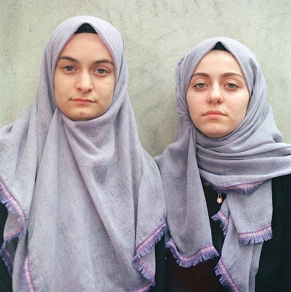 Two sisters wearing headscarves on their graduation from a Qur'an school in Kars, Turkey.