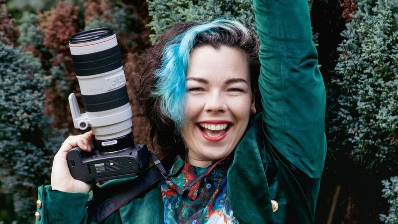A headshot of Canon Ambassador Morgane Gielen holding a Canon camera.
