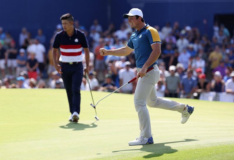 Golfer Viktor Hovland celebrates a birdie, another golfer and the crowd out of focus behind him. Taken on a Canon EOS R3 with a Canon RF 100-300mm F2.8L IS USM lens.