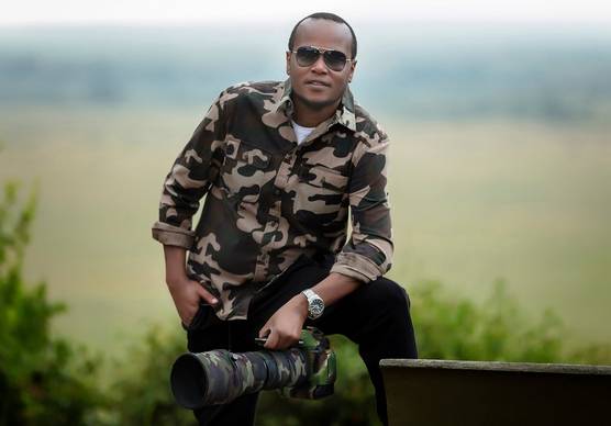 Photographer and Canon Ambassador Clement Kiragu with a Canon camera and long lens.