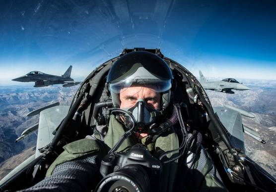 Photographer and Canon Ambassador Massimo Sestini in a fighter jet with his Canon camera.