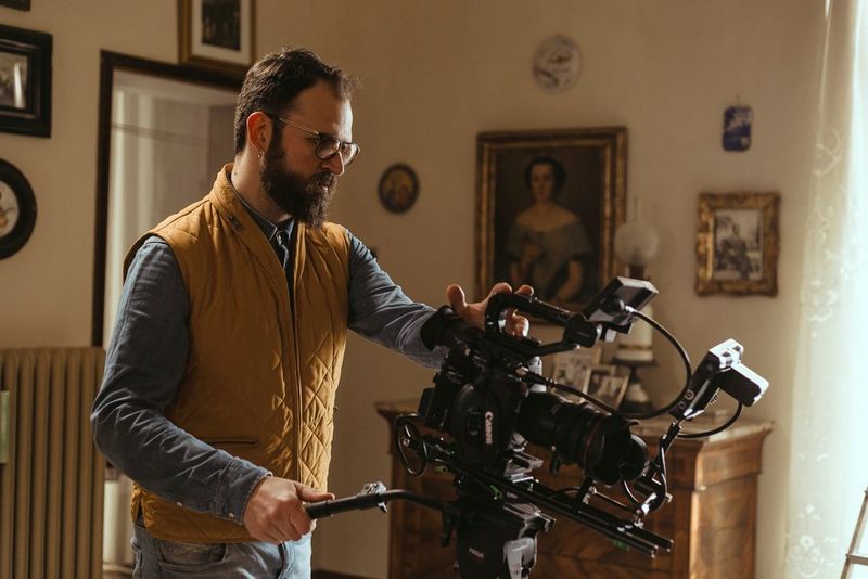 Cinematographer Ivan D'Antonio shooting with a Canon Cinema EOS camera in a small room with old-fashioned décor.