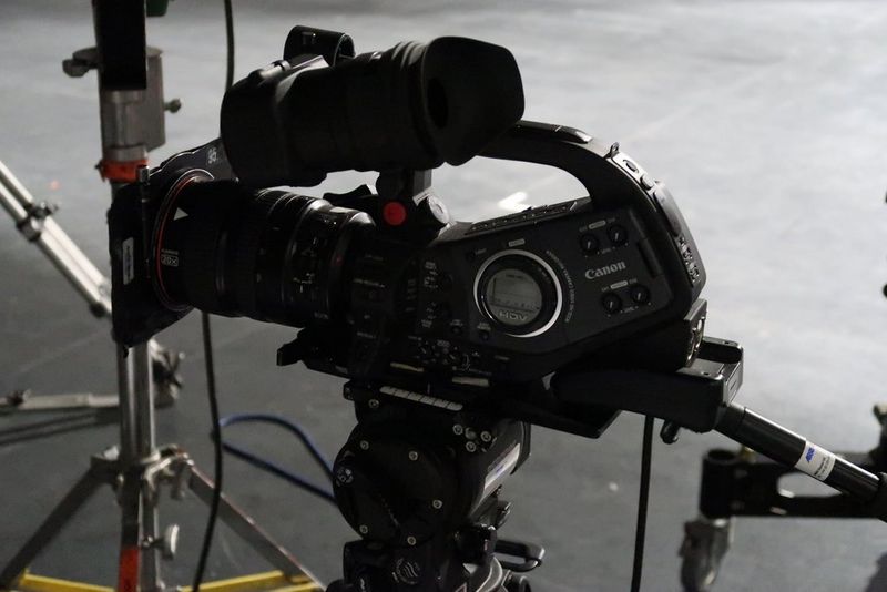 A close-up of a Canon XL H1 camcorder on a TV set.