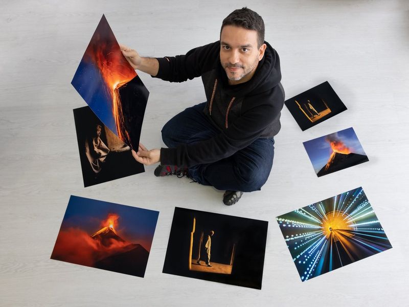 Canon Ambassador Joel Santos sits on the floor surrounded by photographs he has printed on a Canon PIXMA PRO-200. 