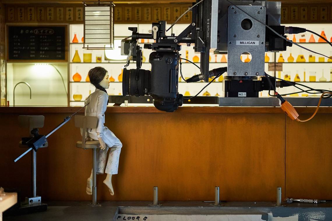 A Canon EOS-1D X camera mounted on a motion control rig and positioned next to a puppet on the set of Wes Anderson's Isle of Dogs. 