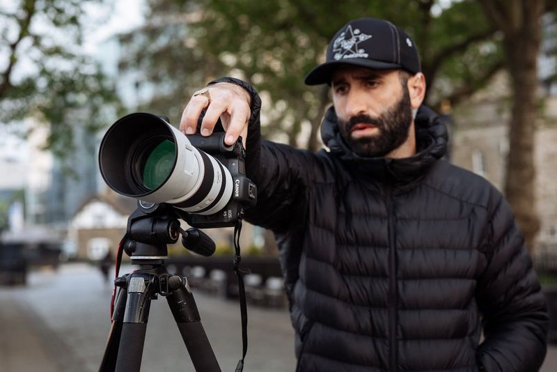 A Canon EOS R5with a Canon EF 70-200mm F/2.8L IS III USM lens is pointed towards Tower Bridge, with the Tower of London in the background.