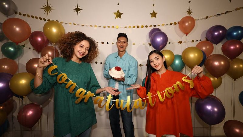 Three people posing for a picture during a celebratory party. Taken with Canon EOS R8, RF15-30mm F4.5-6.3 IS STM and Canon Speedlite EL-10.