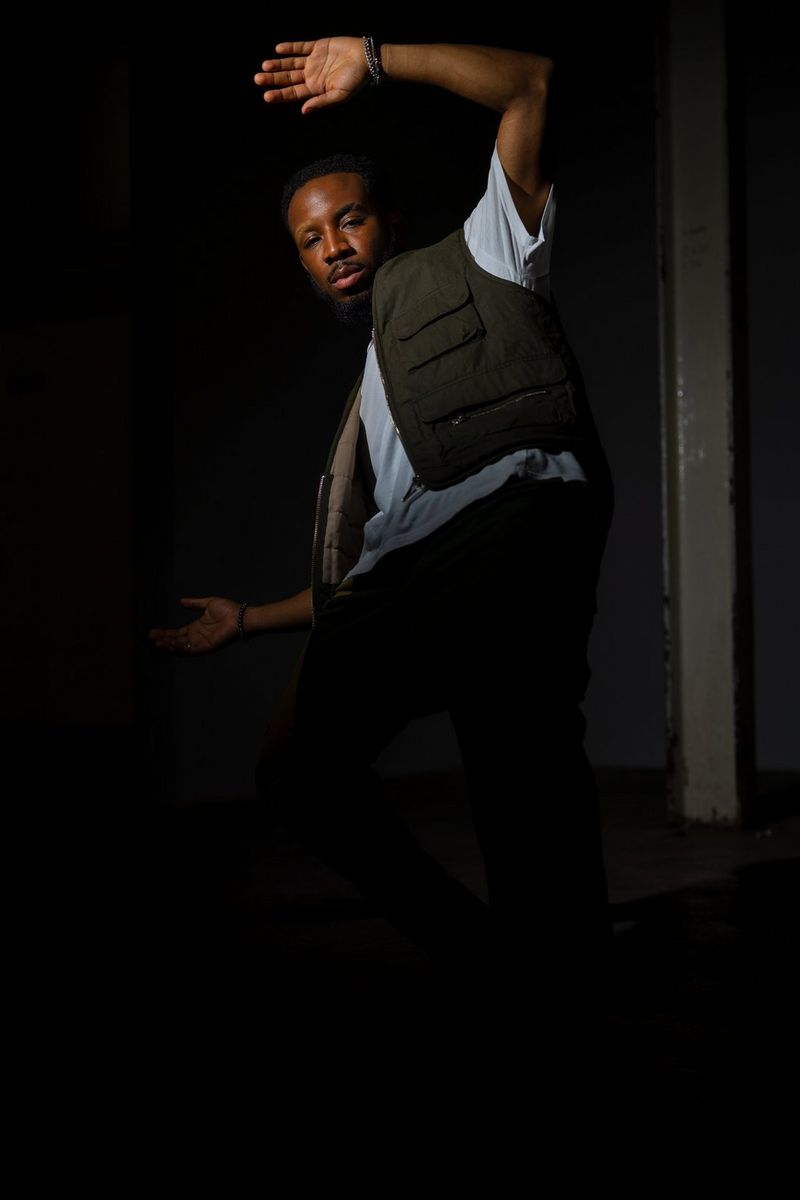 Shot without flash, a dancer is barely visible against the dark background.