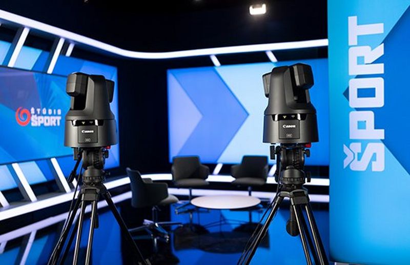 Two Canon PTZ cameras positioned for live broadcast in a sports studio.