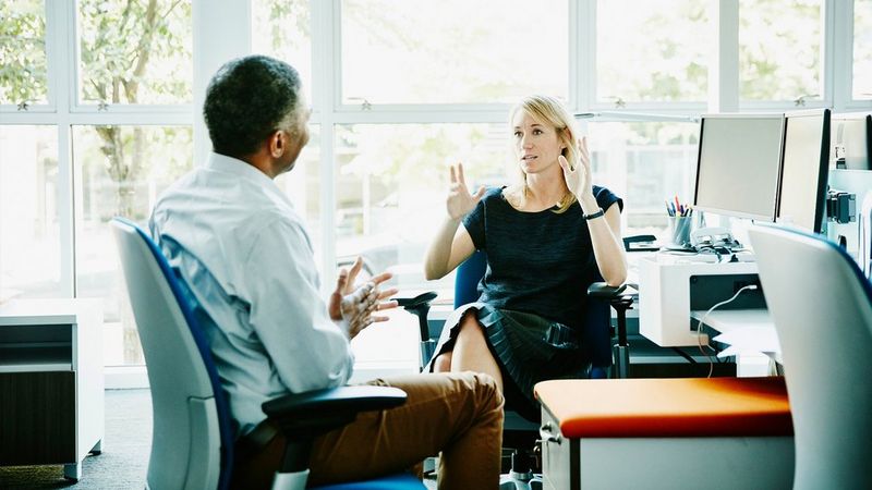 an image of two adults talking to each other 