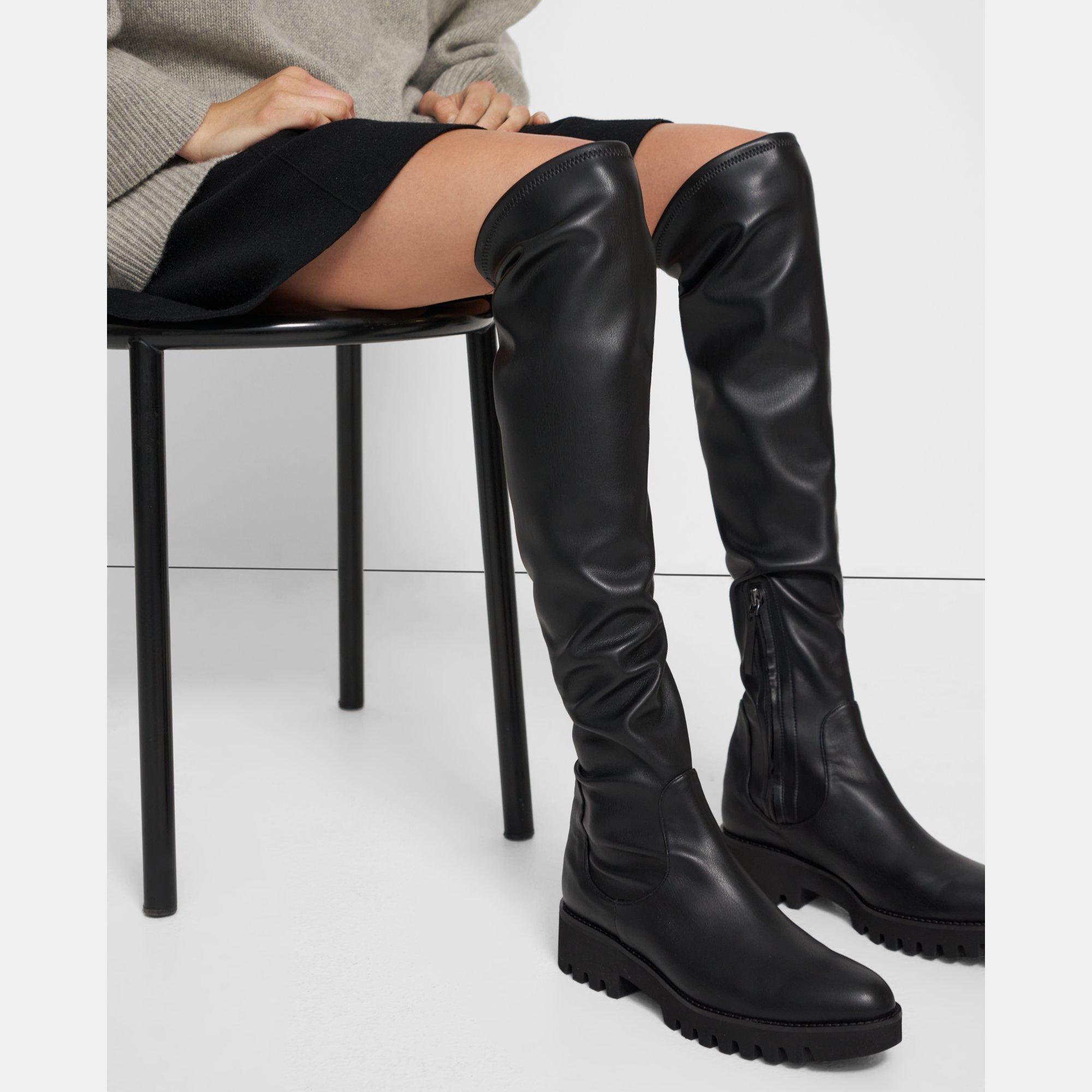 brings a new sensibility to statement footwear with these toe-capped black  over-the-knee boots