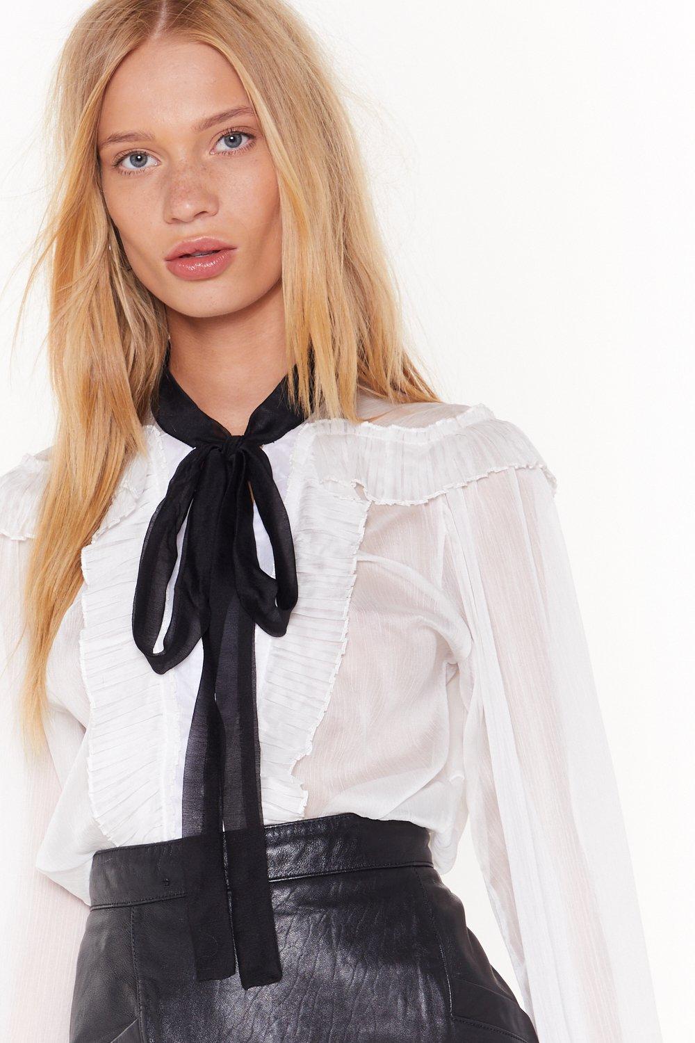 white ruffle blouse with black tie