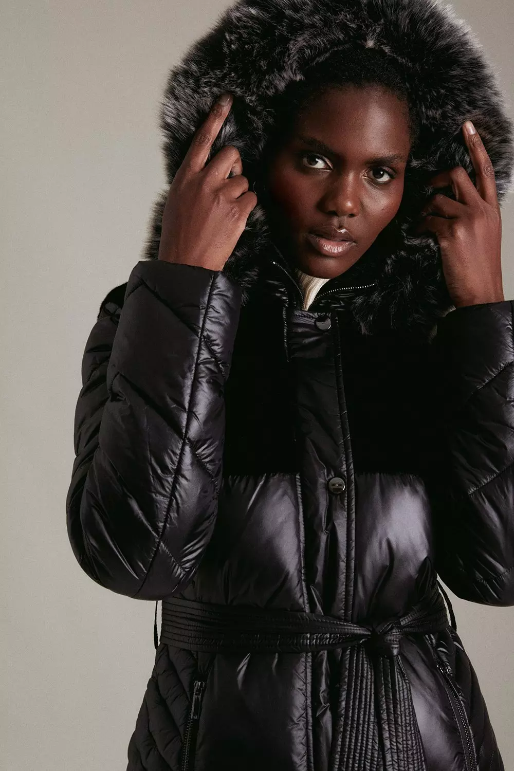 Black high shine coat store with faux fur hood