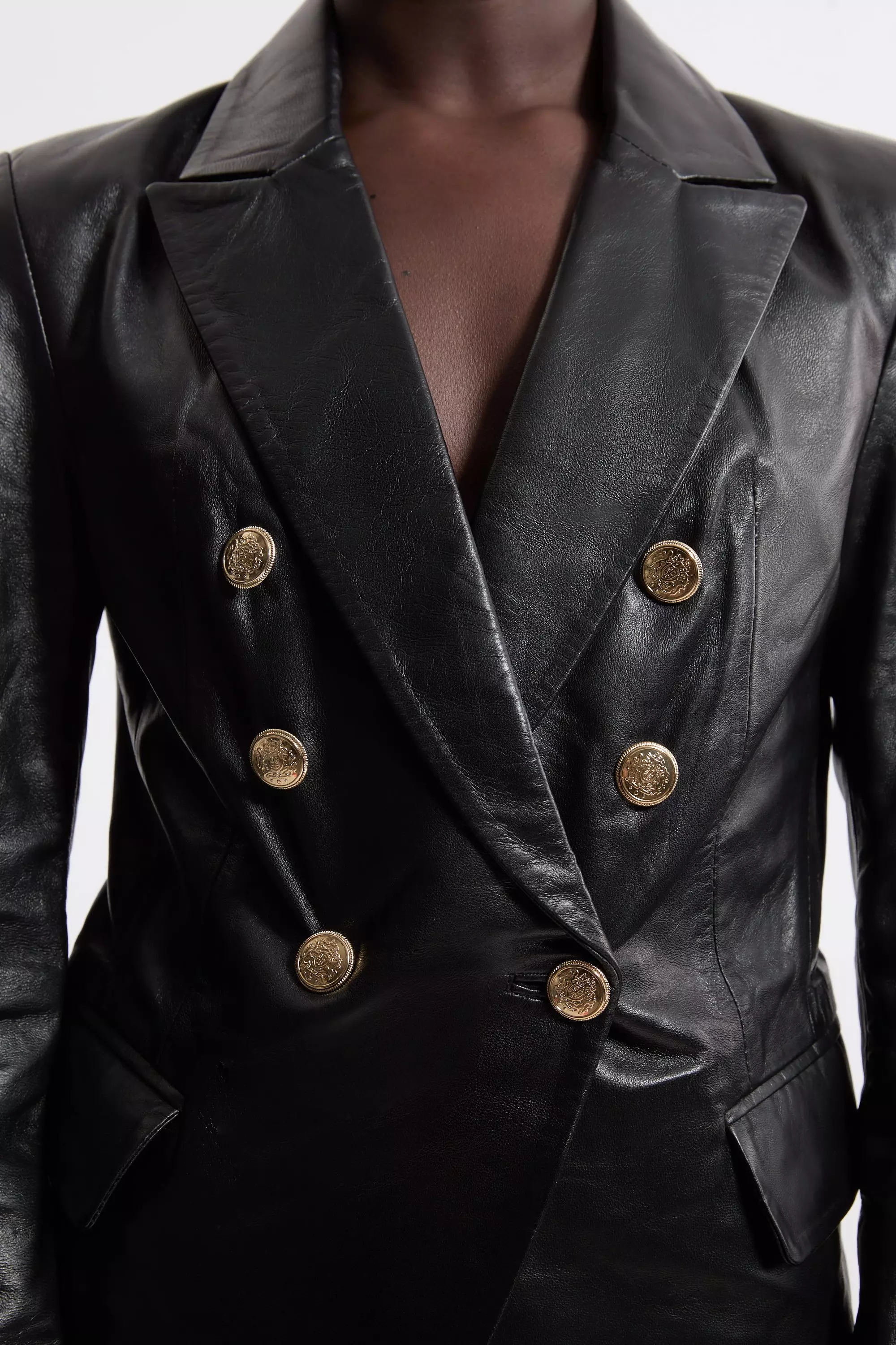 Black leather jacket with cheap gold buttons