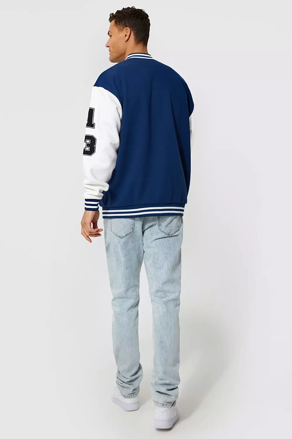 ASOS Design Oversized Varsity Jacket with Badges in Blue