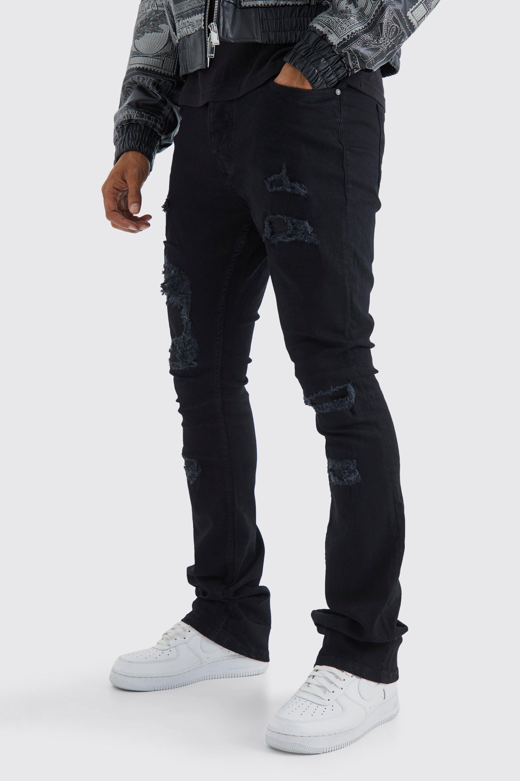 Image of Jeans Skinny Fit strappati con pieghe sul fondo e smagliature, Nero