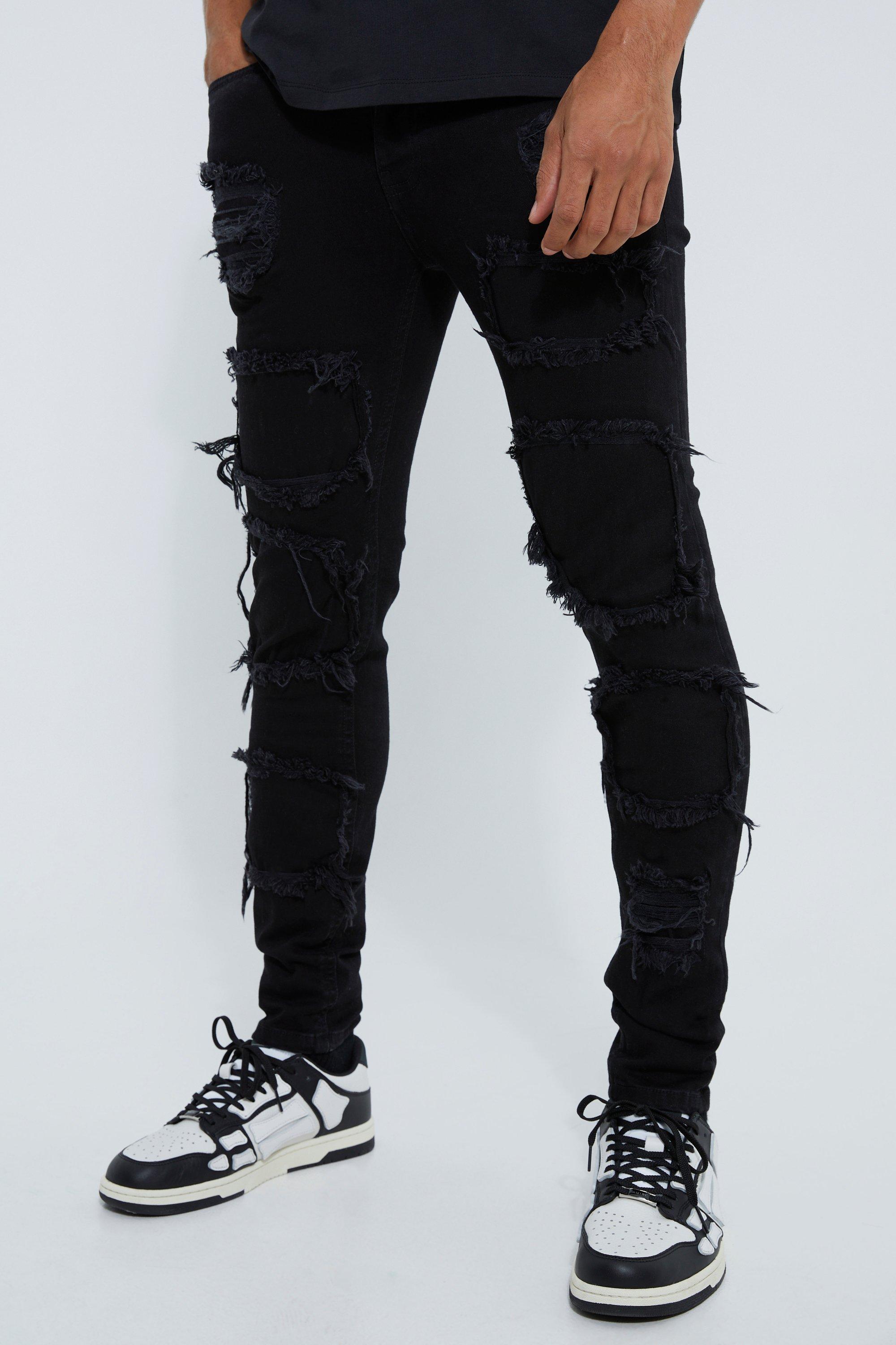 Image of Jeans Skinny Fit strappati con pieghe sul fondo e smagliature, Nero