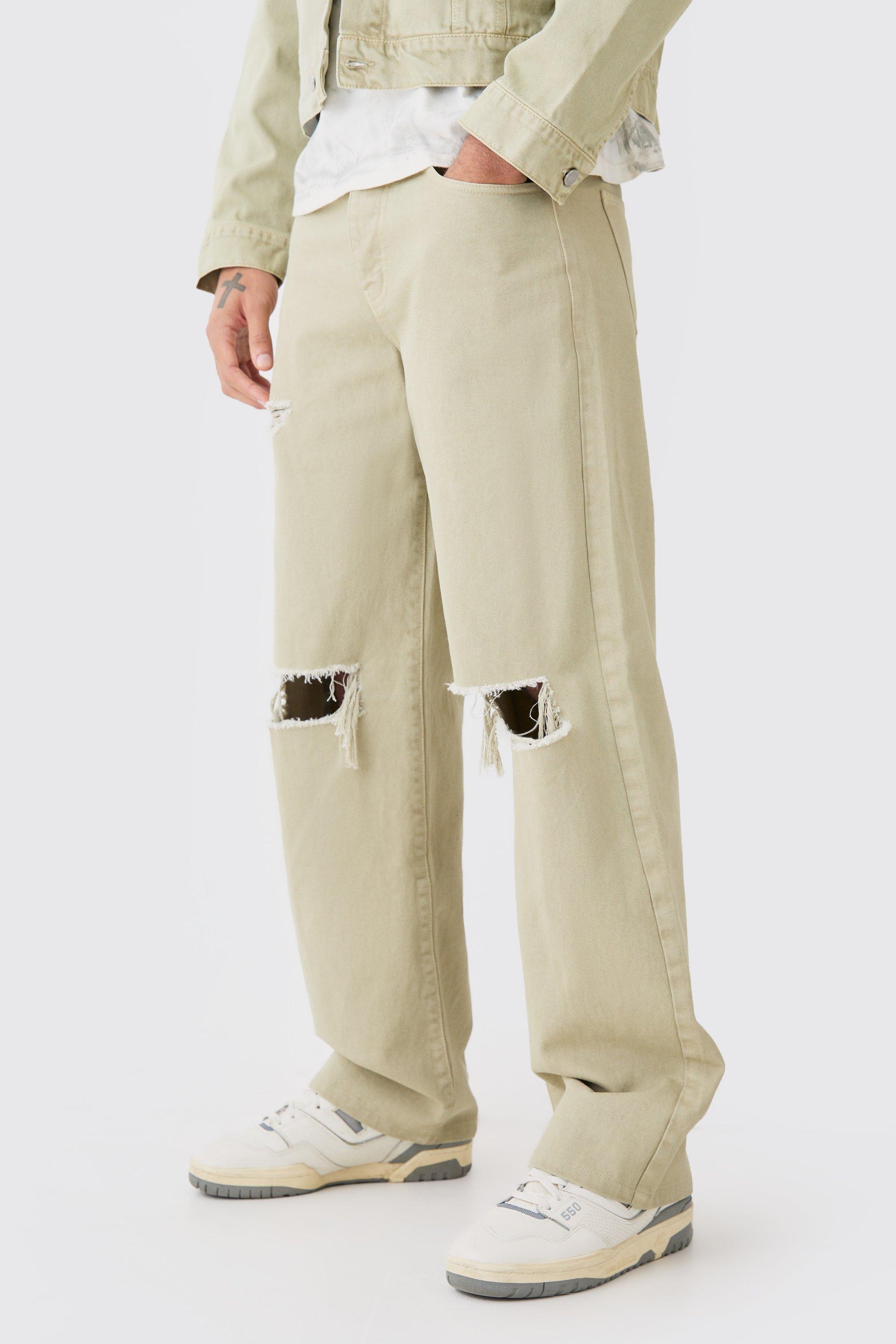 Image of Jeans extra comodi in denim rigido sovratinto con strappi sul ginocchio, Verde