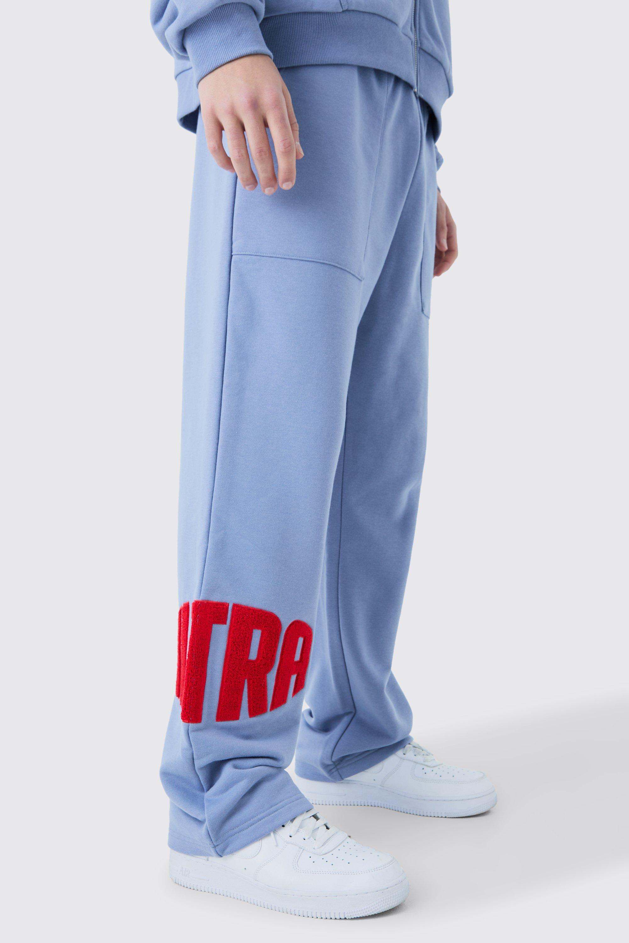 Image of Pantaloni tuta dritti in pile borg con applique, Azzurro