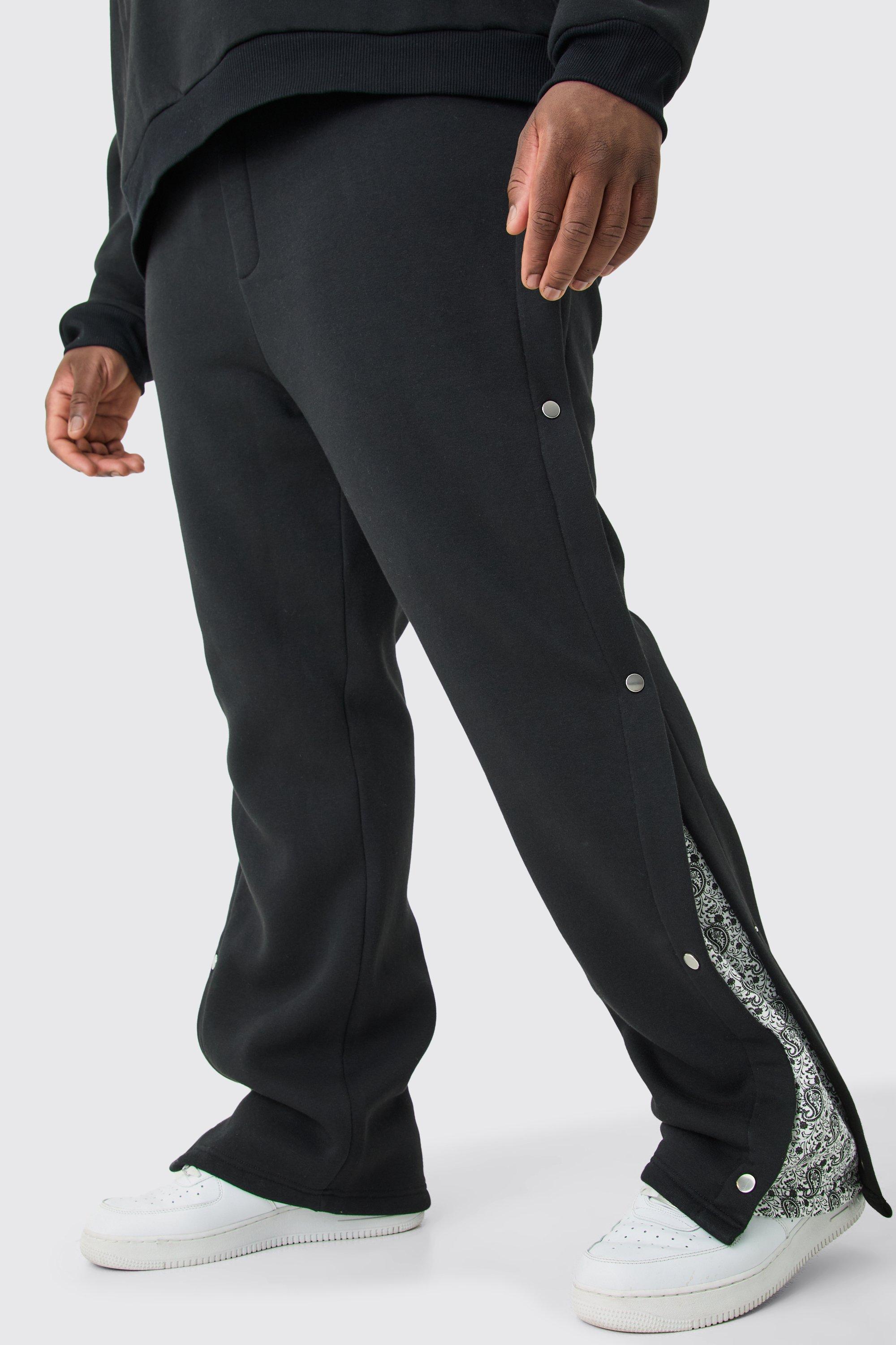 Image of Pantaloni tuta Plus Size rilassati con stampa e pannelli laterali con bottoni a pressione, Nero