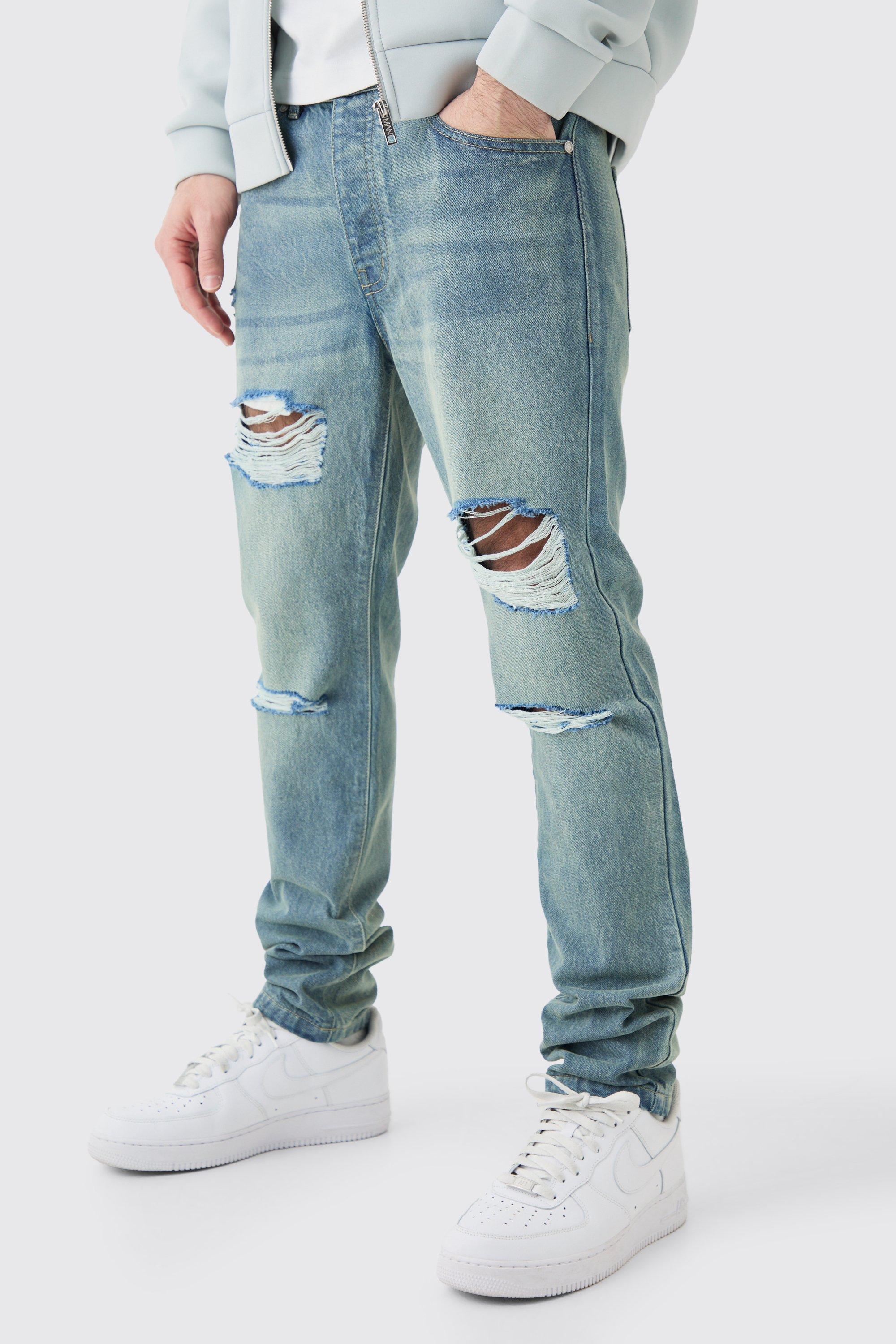 Image of Jeans Slim Fit in denim rigido blu antico con strappi all over, Azzurro
