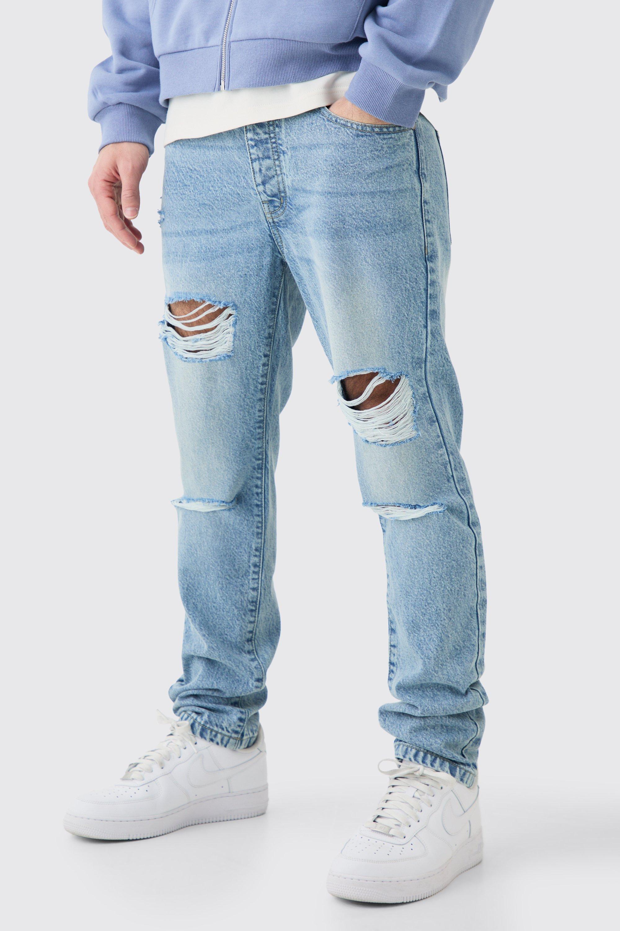 Image of Jeans Slim Fit in denim rigido azzurro con strappi all over, Azzurro
