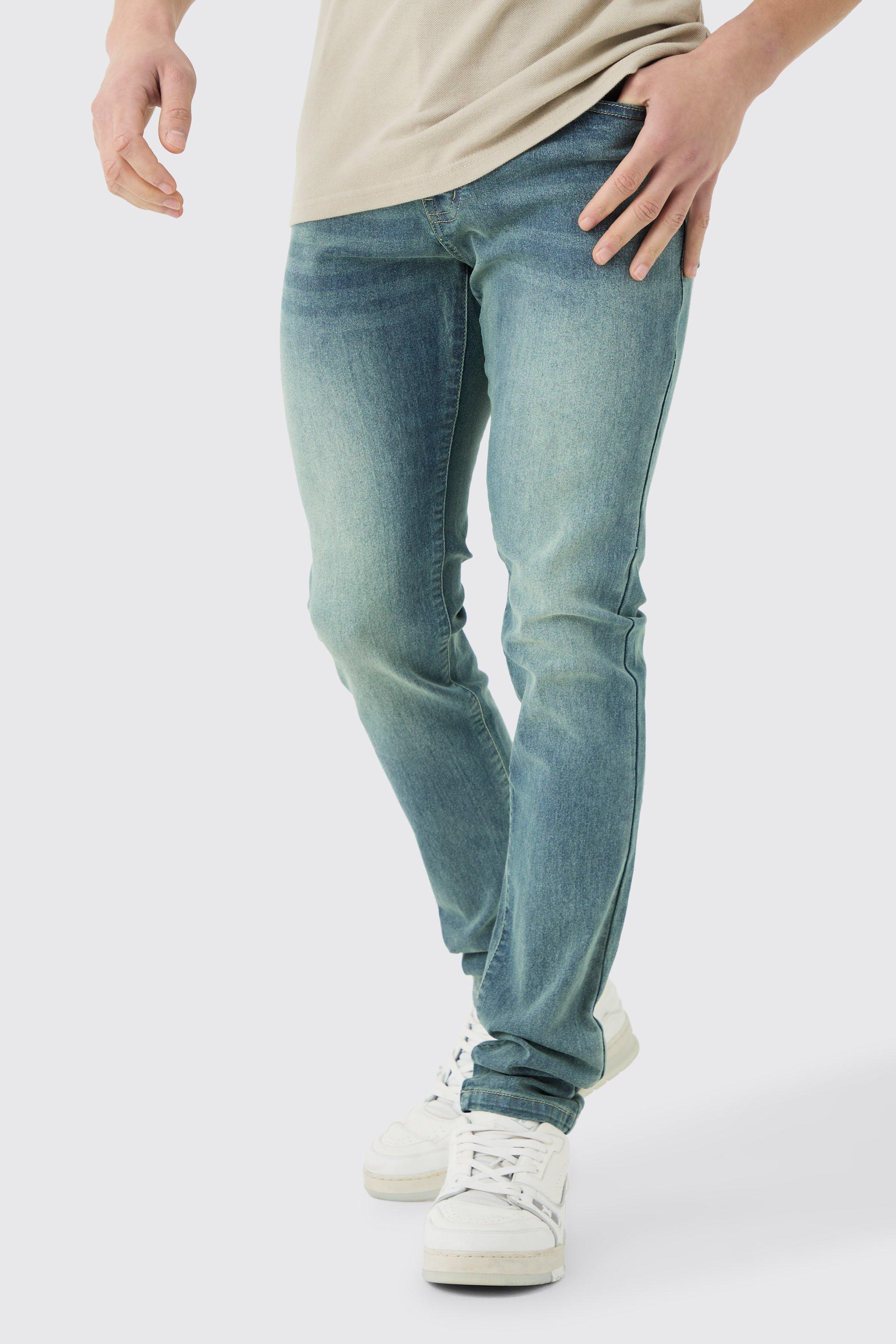 Image of Jeans Skinny Fit Stretch con pieghe sul fondo blu antico, Azzurro