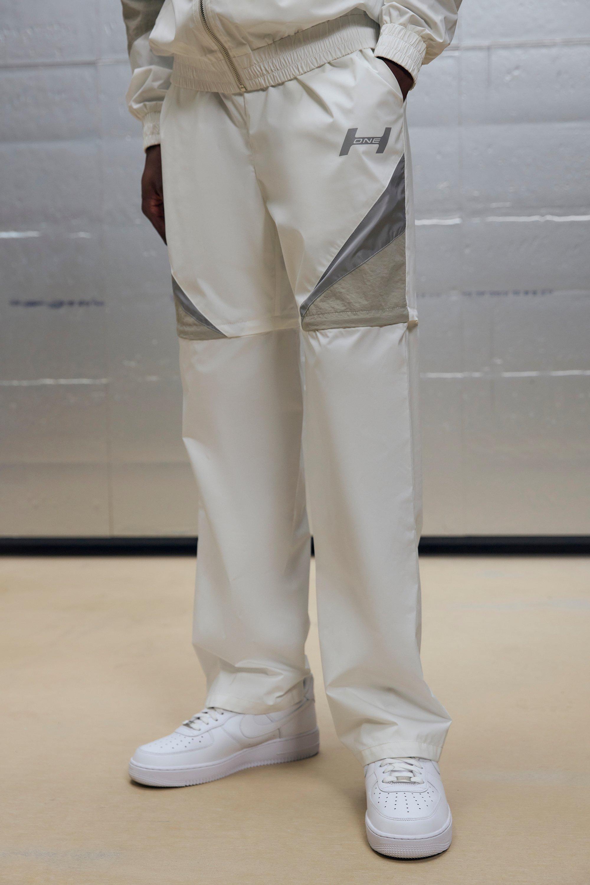 Pantaloni rilassati in nylon effetto goffrato con pannelli e zip, Bianco