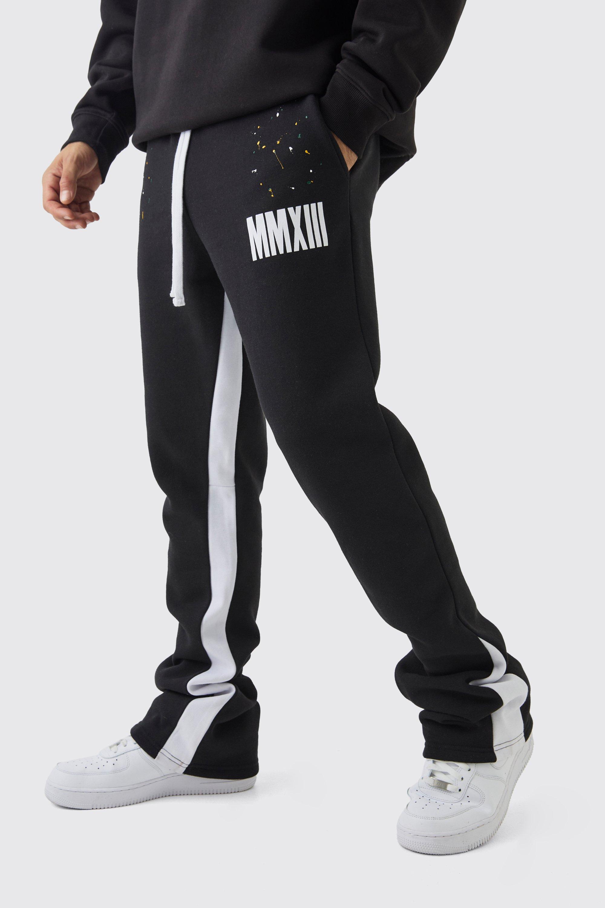 Pantaloni tuta a zampa Slim Fit Man con pieghe sul fondo e schizzi di colore, Nero