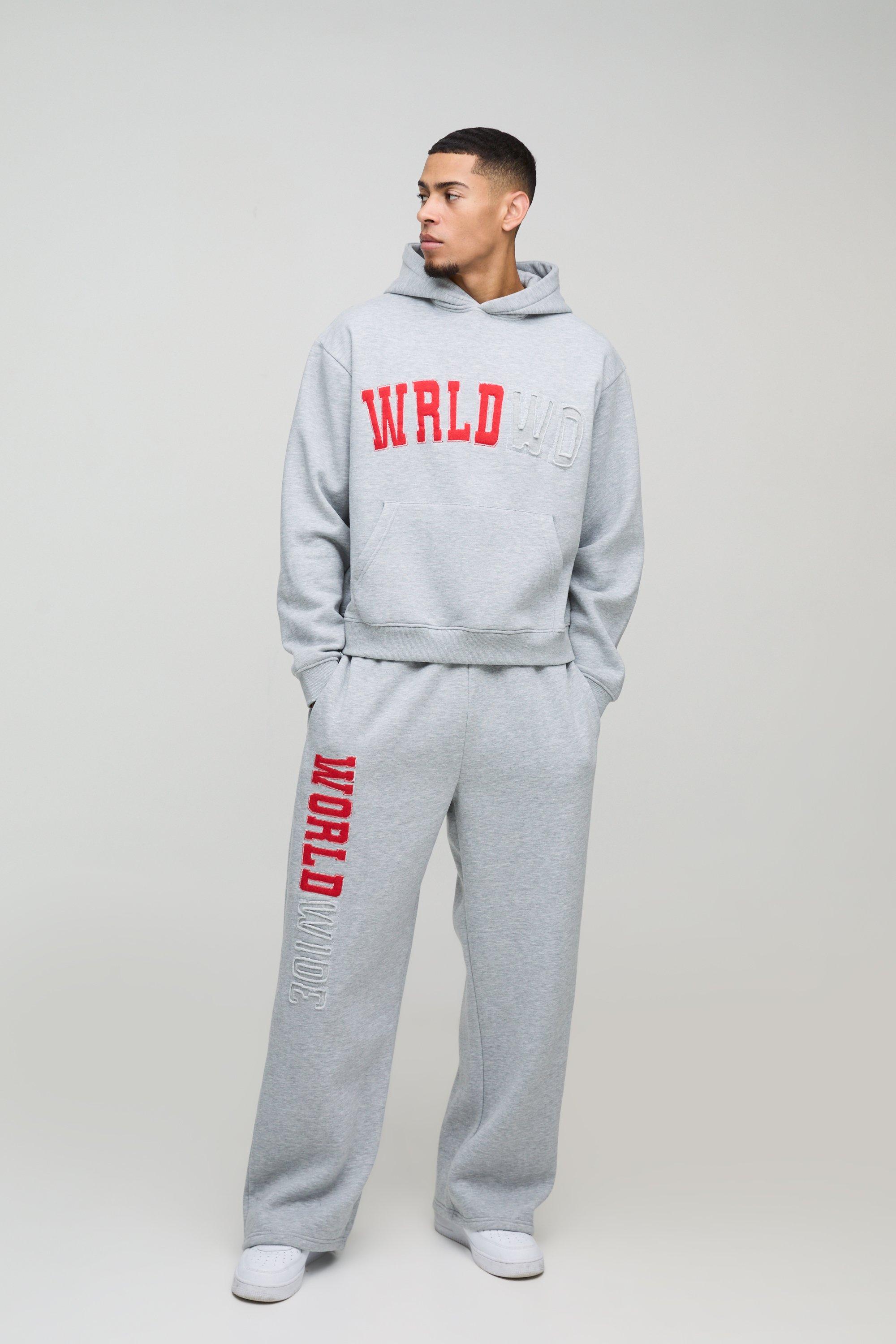 Tuta sportiva squadrata oversize Worldwide effetto smagliato con applique e cappuccio, Grigio