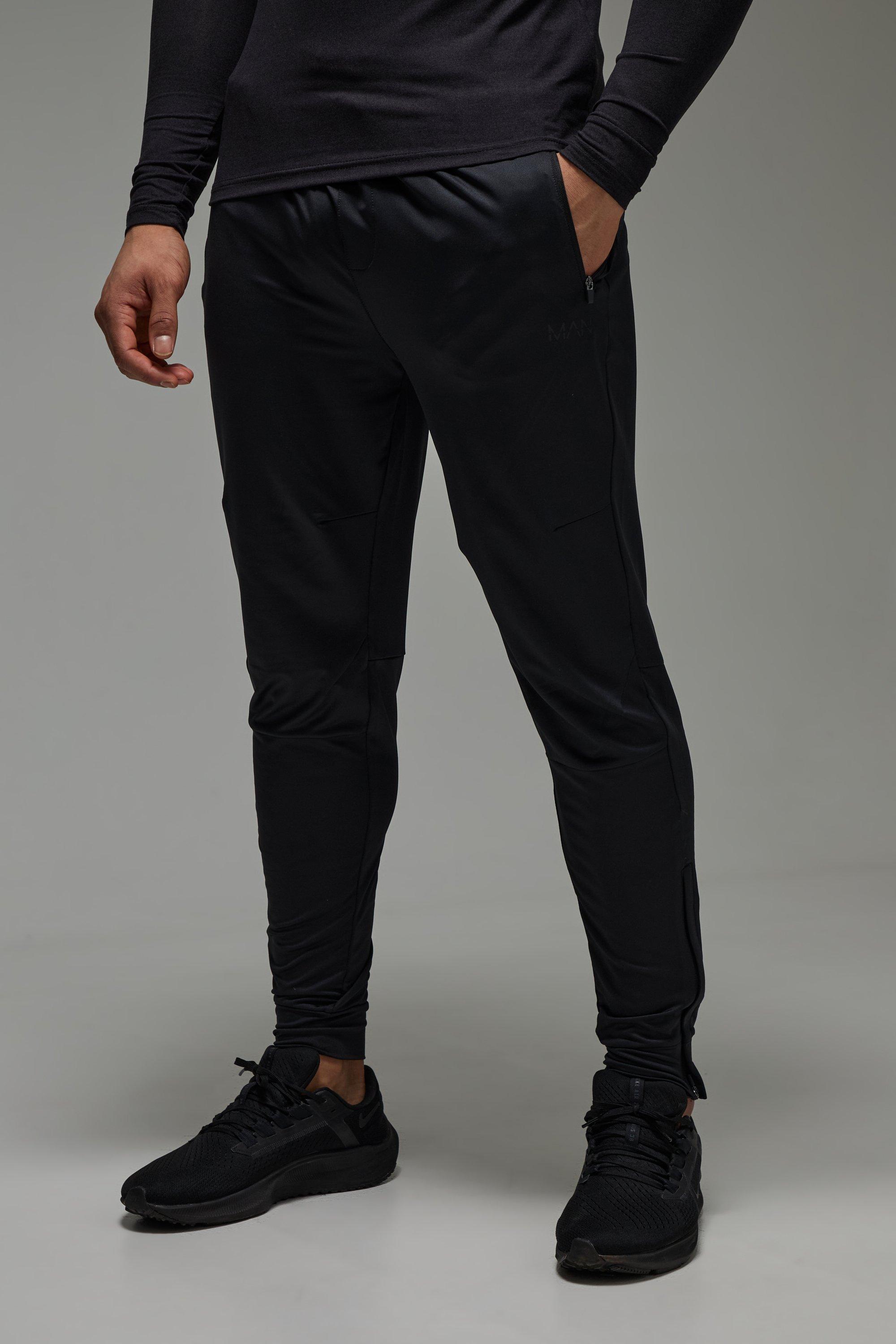 Pantaloni tuta affusolati Man Active Stretch con zip sul fondo, Nero